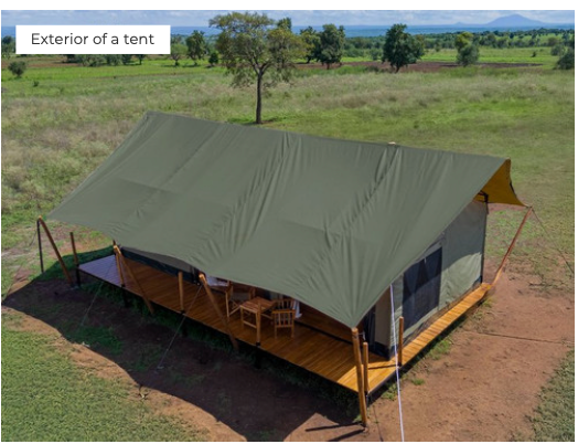 Exterior of a tent with a wooden deck in a grassy field