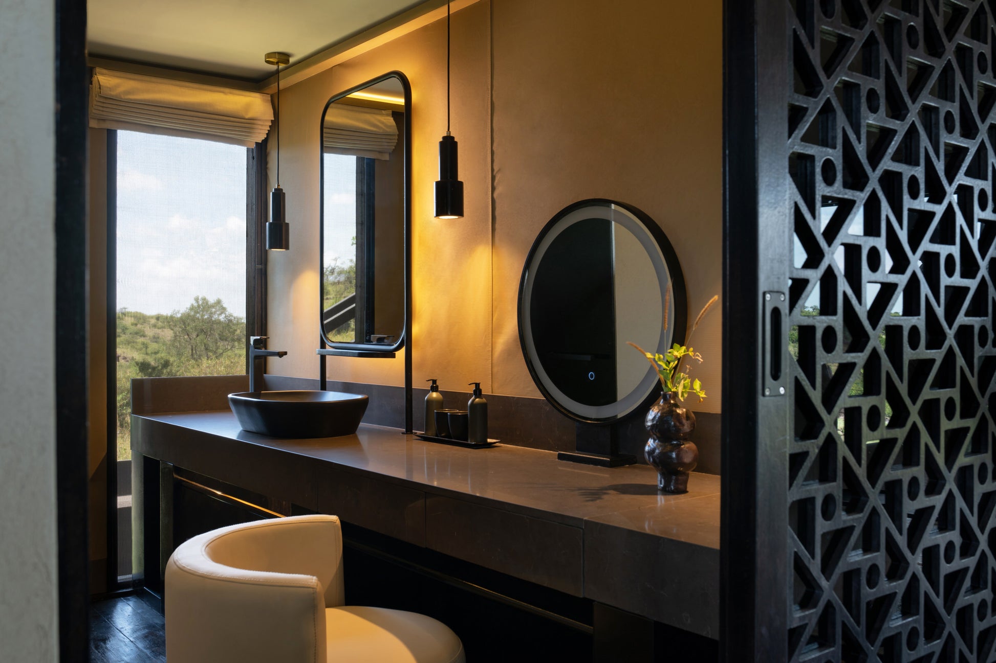 Bathroom vanity with mirrors and decorative elements, featuring a window view.