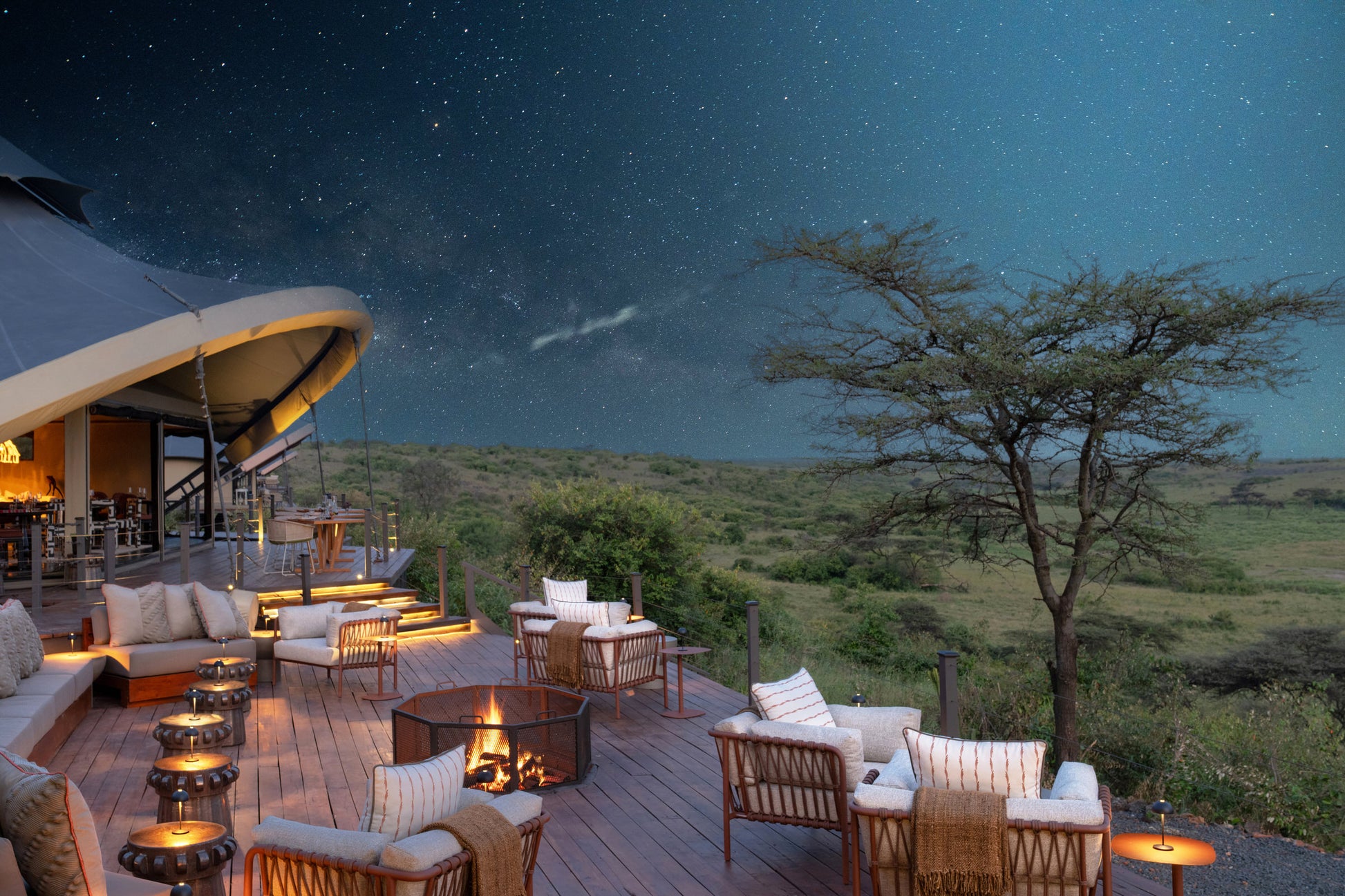 Evening outdoor setting with safari-style accommodation and starry sky
