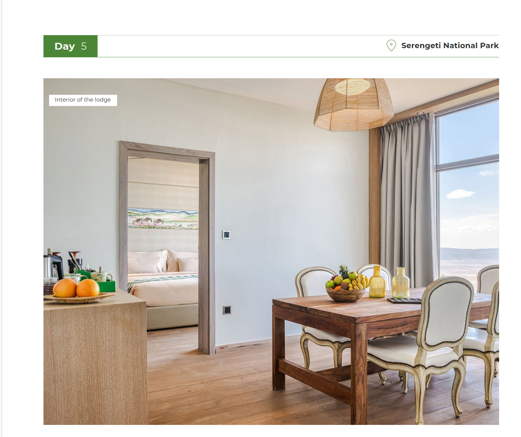 Modern interior of Four Seasons Lodge with a dining table and view of Serengeti National Park.