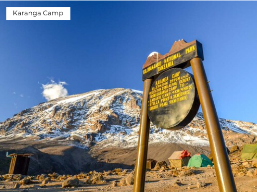 Sign for Karanga Camp with Mount Kilimanjaro in the background