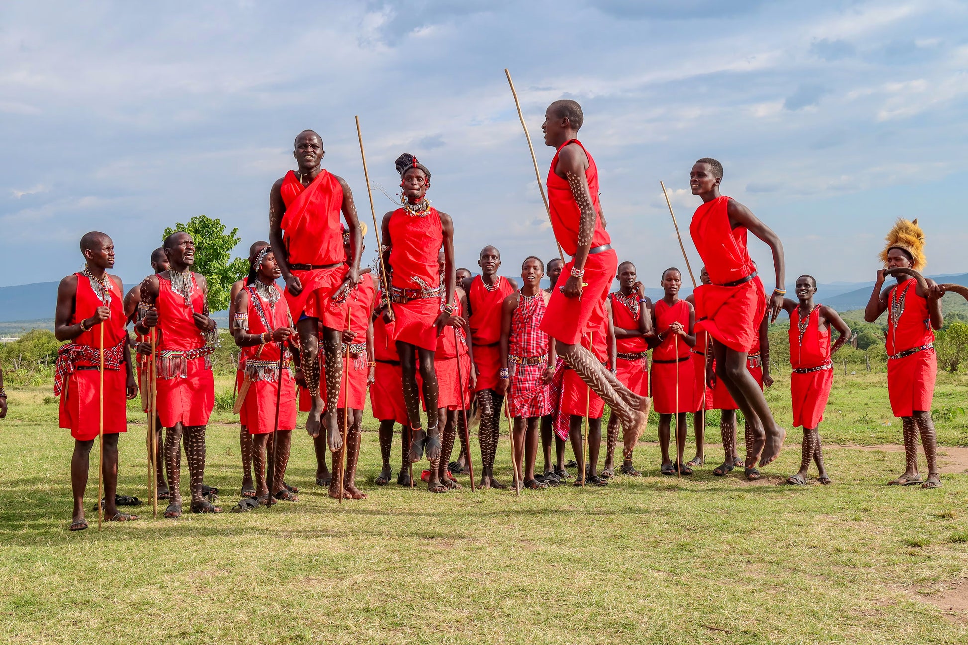 Group of Maasai in their traditional attire dancing.
