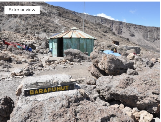 Hut on a rocky mountain with 'Barafuhut' sign, exterior view